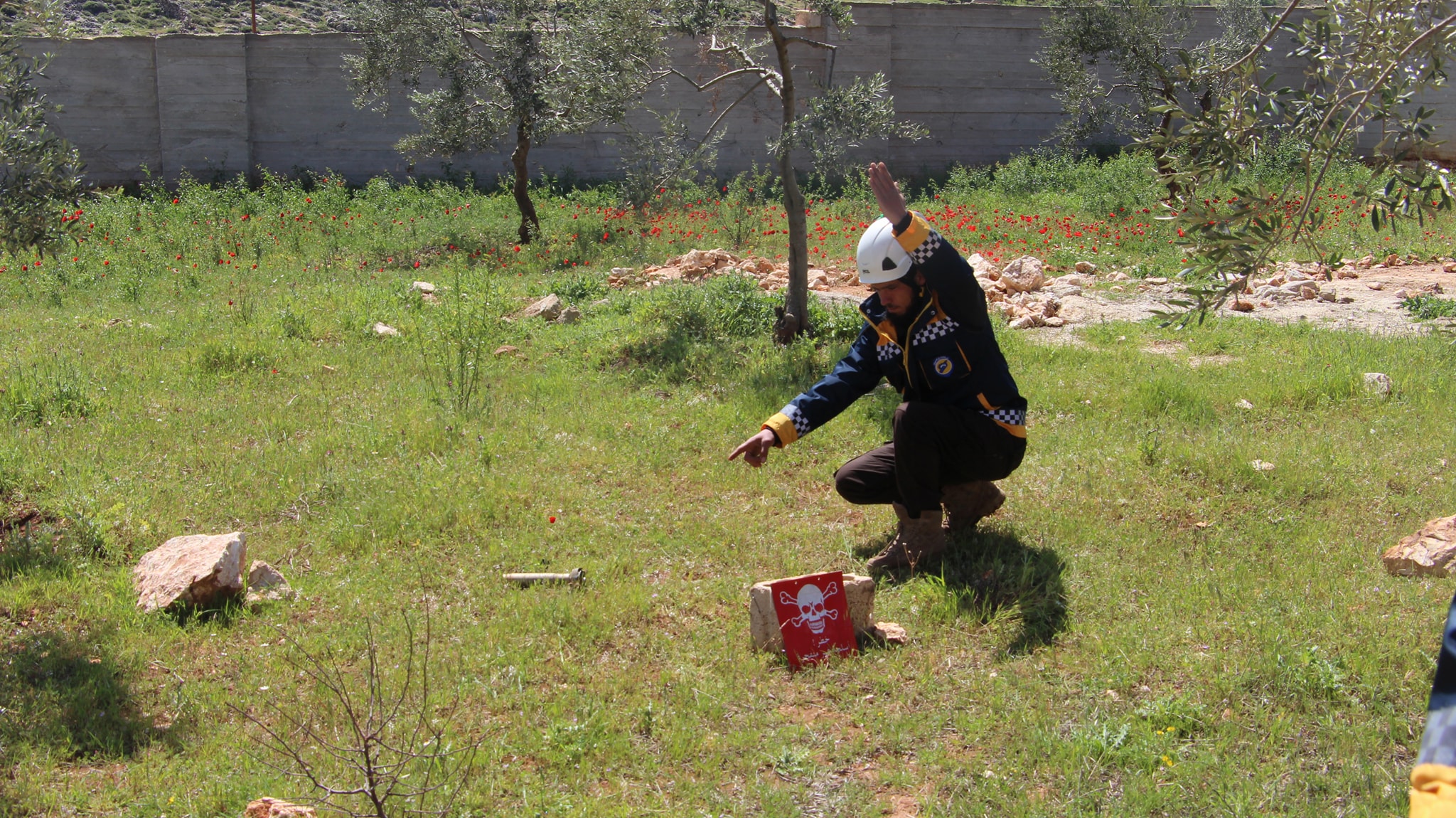 A White Helmentt is locating an unexploded munition