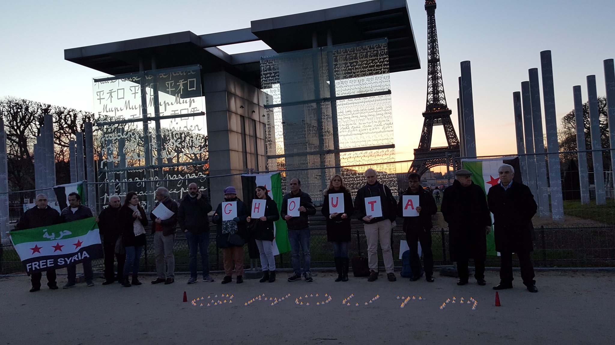 The sit in next to the Wall of peace in Paris