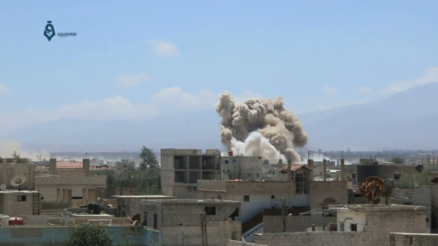 Two bombs are dropped by the Syrian Arab Air Force on the city of Darayya, southwest of Damascus, during its siege.